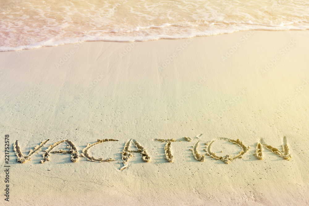 Fototapeta premium Handwritting inscription Vacation word on beach