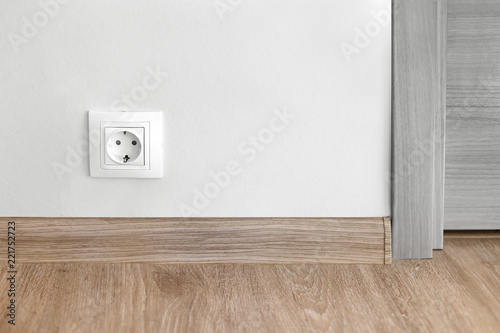 Electric socket mounted on wall at modern flat