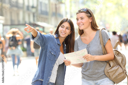 Girl helping to a tourist who asks direction photo
