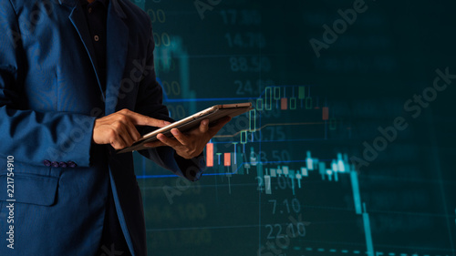 Canvas Print Businessman finger touching tablet with finance and banking profit graph of stock market trade indicator financial, Financial chart with up trend line graph