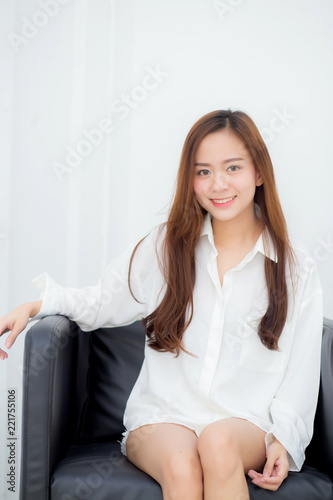 Portrait of beautiful young asian woman smile and happy sitting on chair in the living room at home, lifestyle and relax concept. Free Download Portrait of beautiful young asian woman smile and happy sitting on chair in the living room at home, lifestyle and relax concept. - GFXLoad