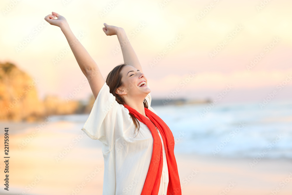 Excited woman celebrating sunset raising arms - obrazy, fototapety, plakaty 