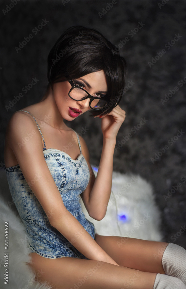 Sexy glamorous brunette with short hair, with glasses and red, lips sitting  in golfins Stock Photo | Adobe Stock
