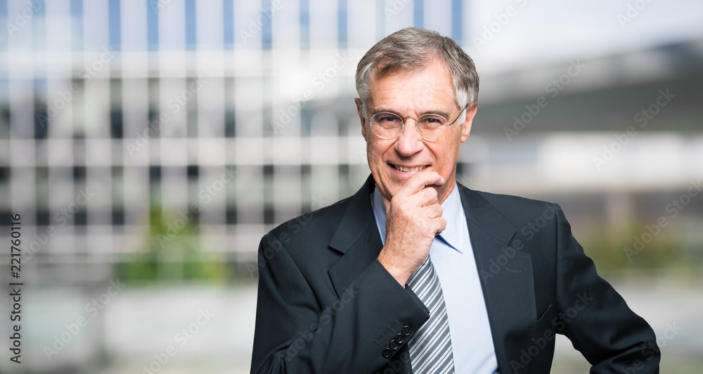 Businessman in front of his office. Wide image Businessman in front of his office. Wide image