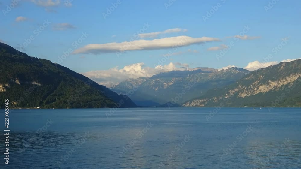 Time lapse view lake Thun (Thunersee) and mountains of Swiss Alps in city Spiez, Switzerland, Europe. Summer landscape, sunshine weather, blue sky and sunny day Time lapse view lake Thun (Thunersee) and mountains of Swiss Alps in city Spiez, Switzerland, Europe. Summer landscape, sunshine weather, blue sky and sunny day