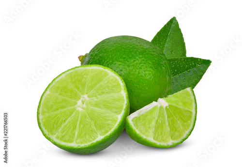whole and slices green lime with green leaf isolated on white background