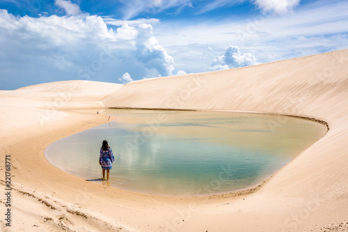Lonaly woman at amazing landscape of Lencois Maranhenses at north of Brazil photo