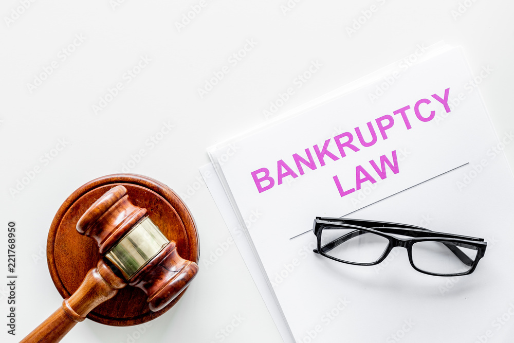 Words bankruptcy law written on the documents near judge gavel on white background top view space for text