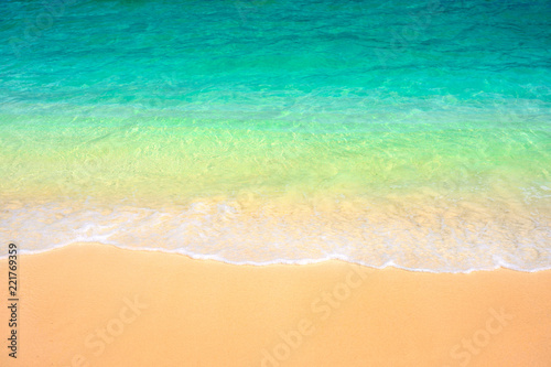 Soft bubble green wave on sandy beach.