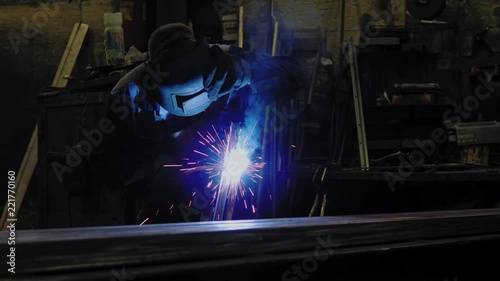 The welder works with metal. Welding of steel. Metal processing. photo