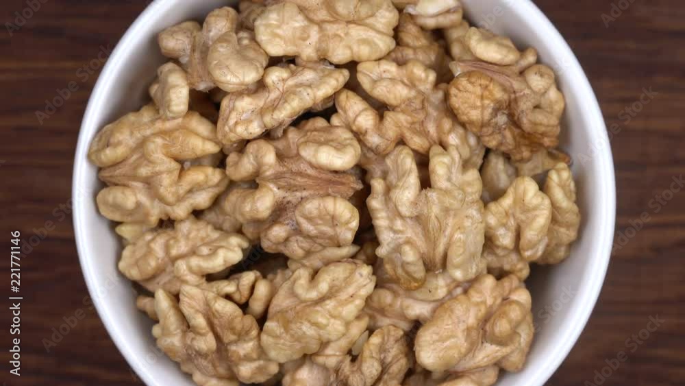 Dry walnut background, close up nut, rotation loopable 4k top view. Food background. Gastronomy concept, organic food. Macro walnuts Dry walnut background, close up nut, rotation loopable 4k top view. Food background. Gastronomy concept, organic food. Macro walnuts