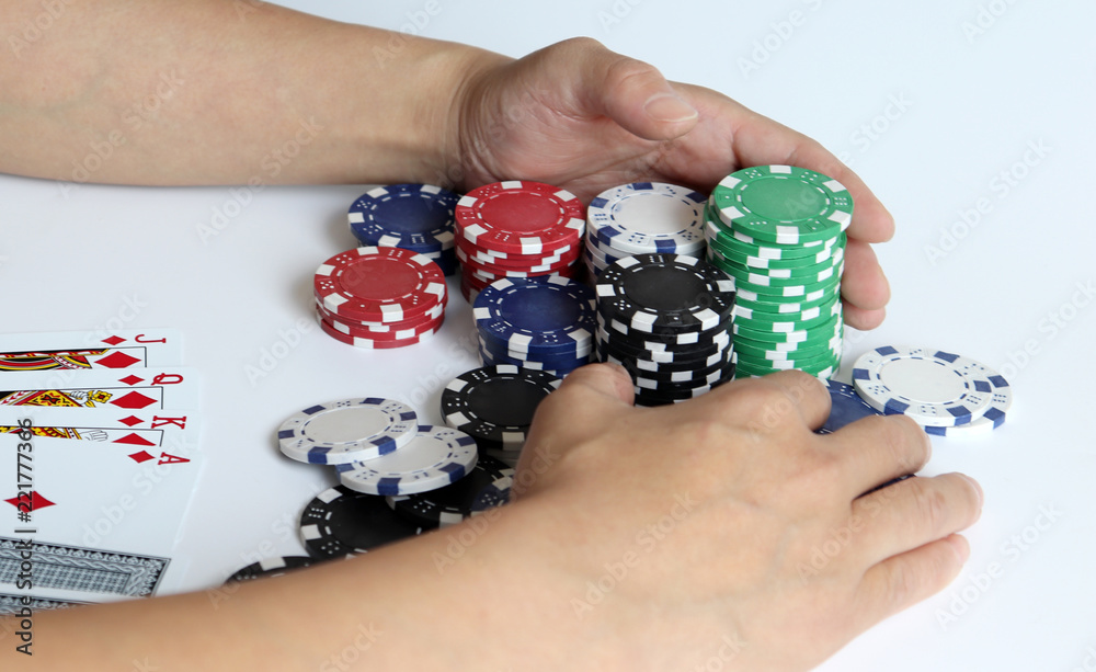 The both hands of a woman pulling a casino chip. The both hands of a woman pulling a casino chip.