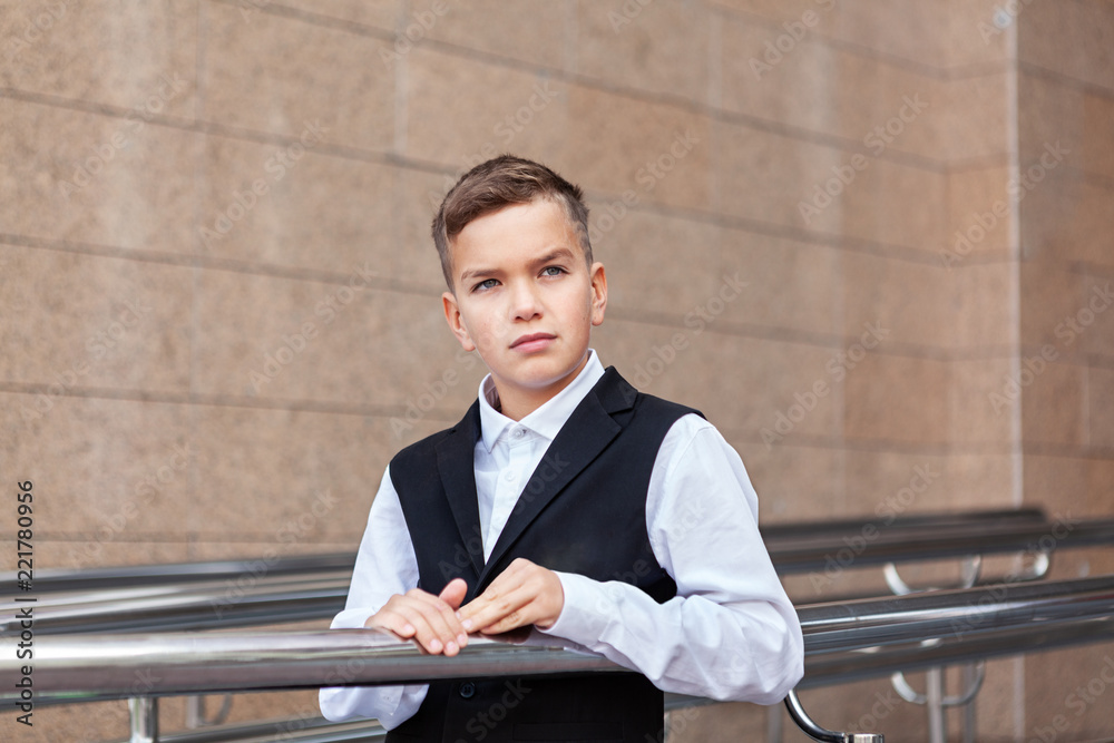 Fototapeta premium Portrait of schoolboy in uniform near school
