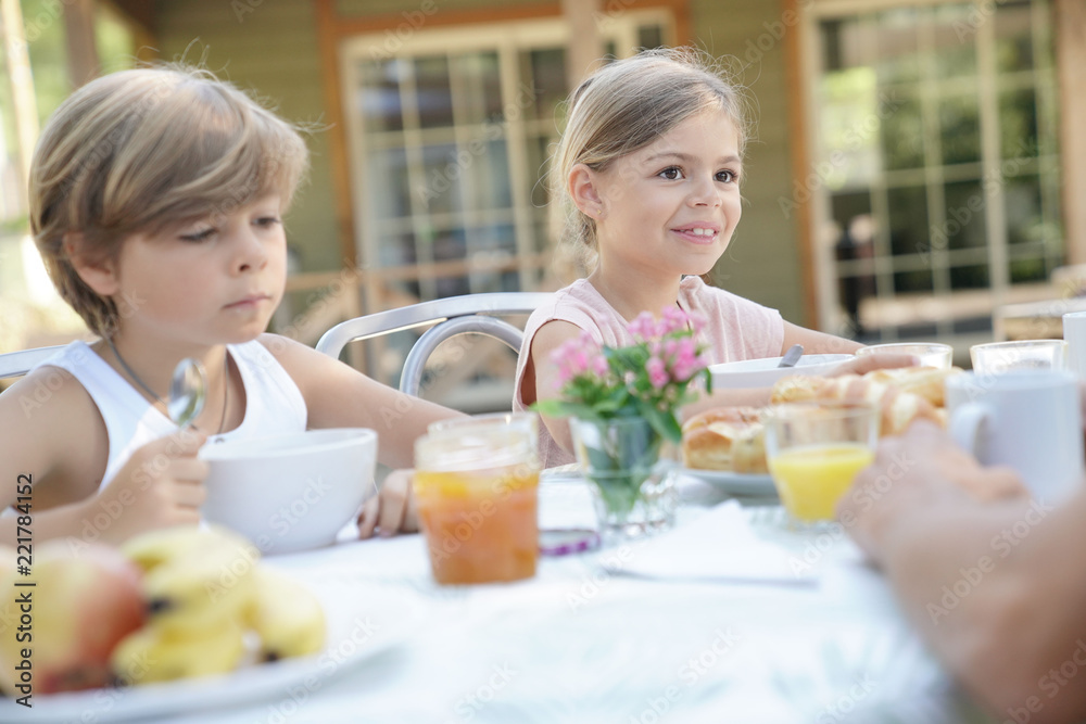 Kids having breakfast outside the house