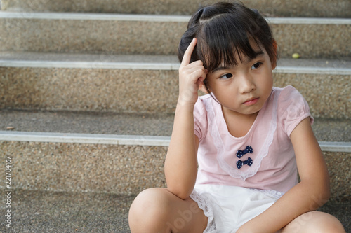 Asian child cute girl Sit thinking