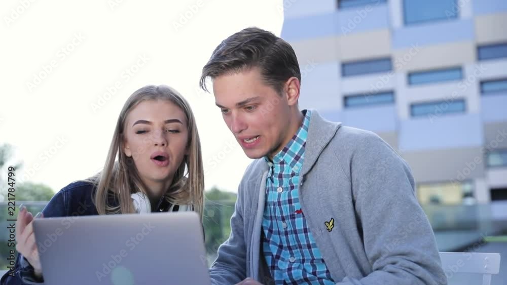 Young Man And Woman Working On Computer Outdoors Young Man And Woman Working On Computer Outdoors