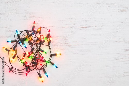 Christmas lights bulb decoration on white wood. Merry Christmas and New Year holiday background. top view