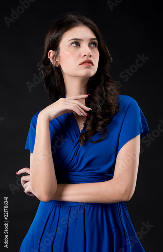 Beautiful girl in Royal Blue dress. on Black screen make her looks elegant. Nice skin and position.