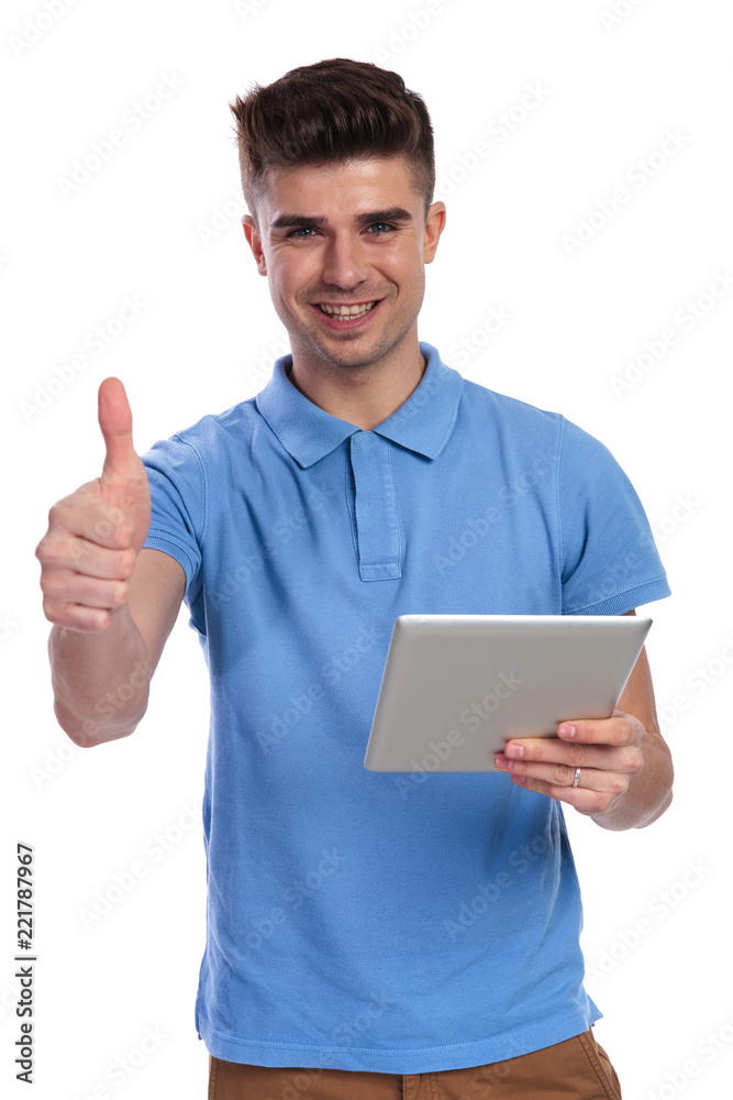 happy casual man working on tablet makes ok sign happy casual man working on tablet makes ok sign