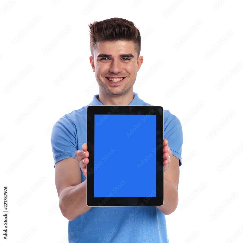 smiling young casual man showing the blank screen of tablet smiling young casual man showing the blank screen of tablet