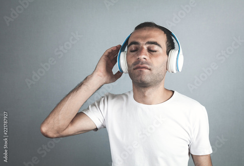 Caucasian man with headphones. Listening music