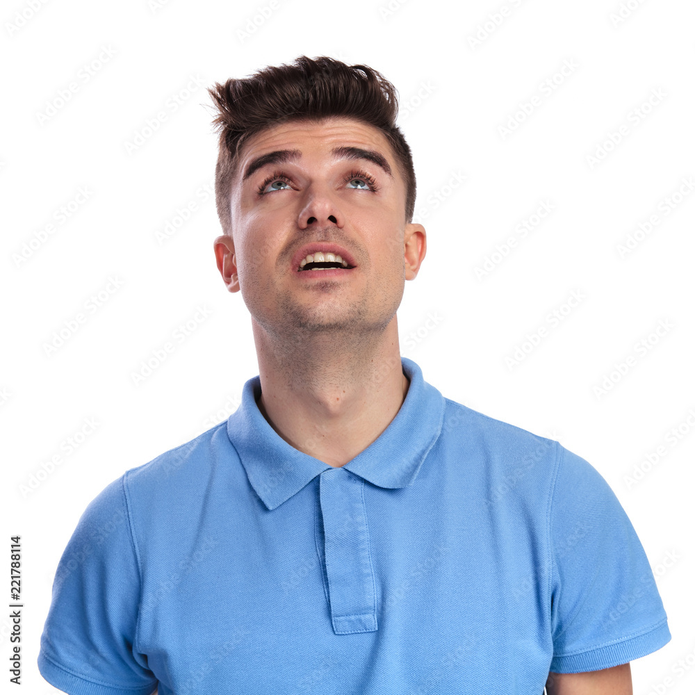 young casual man looks up young casual man looks up
