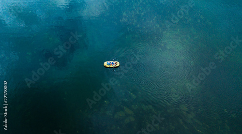 Direct above shot of yellow boat at the surface of the lake © Sanderstock