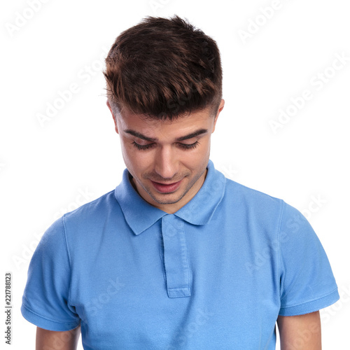 smiling casual man looks down