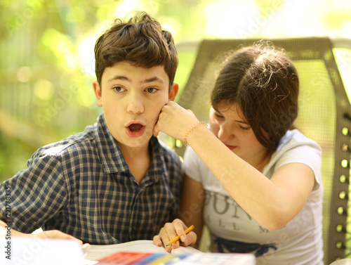 two teenager siblings boy and girl close up photo fighting fist hook hit photo