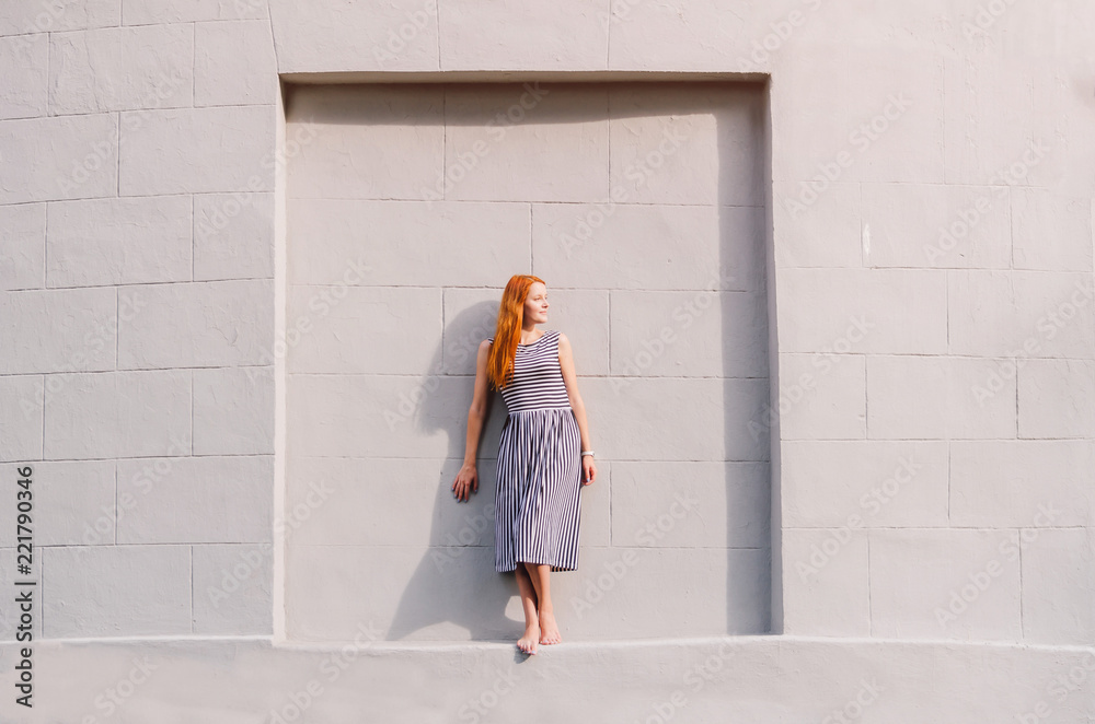 Young redhead woman over a grey background Young redhead woman over a grey background