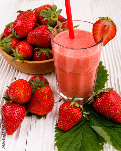 fresh strawberrysmoothie or milkshake on a wooden rustic background photo