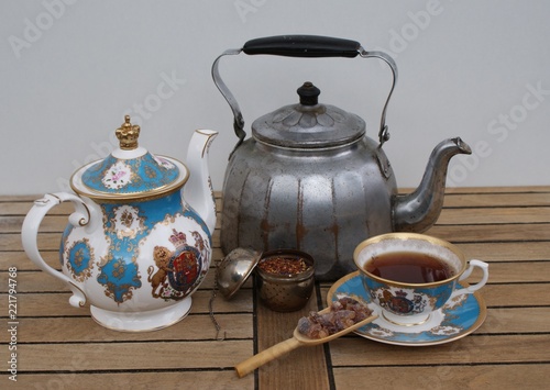 Nostalgic water kettle with english teapot, english tea cup, filled tea infuser and candy