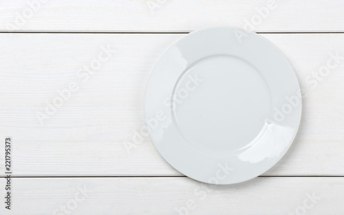Empty, clean white plate on white table