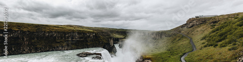 panoramic view of beautiful Gullfoss waterfall flowing through highlands in Iceland