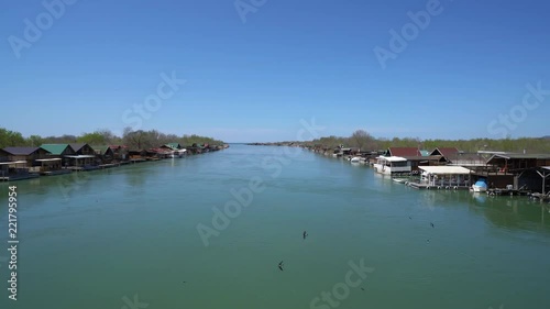 Ada Bojana, Montenegro - April 2018 : Small wooden houses and restaurants on the riverbank of the Ada Bojana river near Ulcinj, Montenegro photo