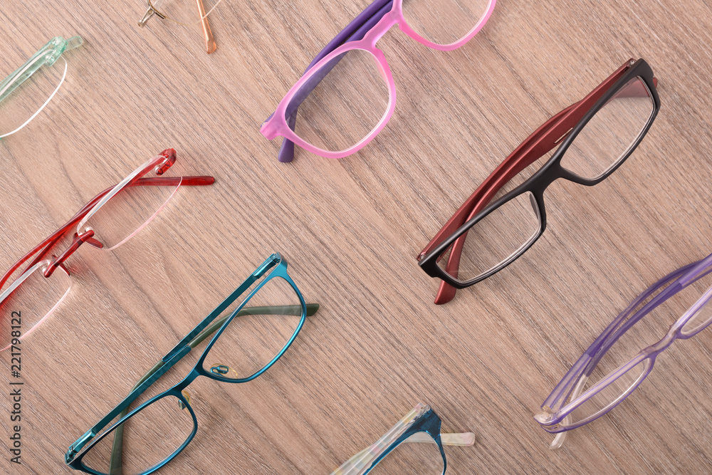 Assortment of glasses on table in an eyewear store top Assortment of glasses on table in an eyewear store top