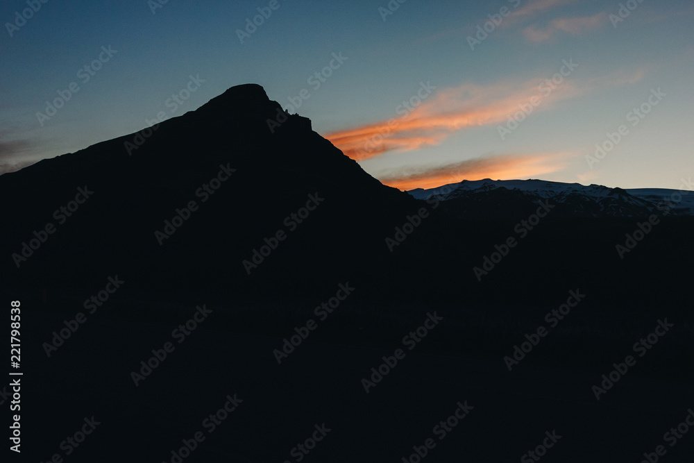 scenic view of mountain in dusk and dramatic sky during sunset in Iceland scenic view of mountain in dusk and dramatic sky during sunset in Iceland