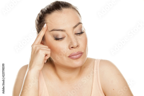 Portrait of nervous thoughtful woman on white background