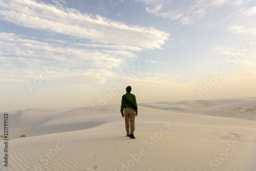 A Traveller exploring the White Sands National Monument at sunset, New Mexico