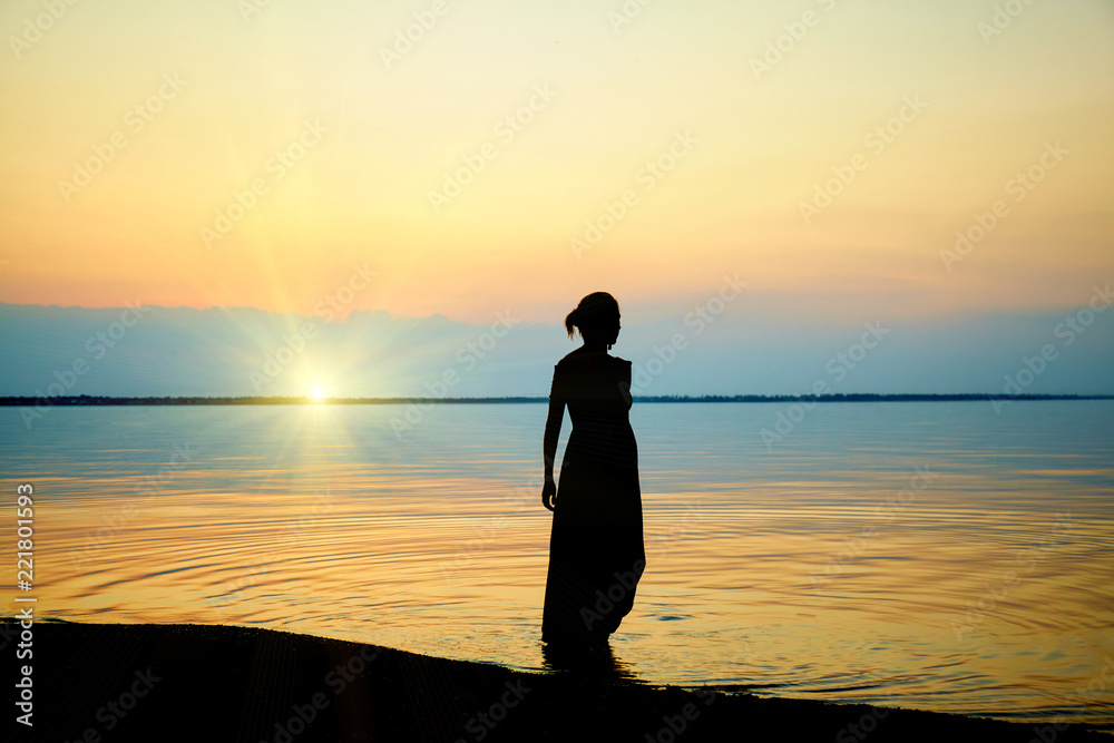 Woman on beach. Sunset at sea