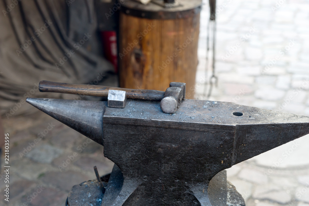 Hammer lies on the anvil in the blacksmith's workshop Hammer lies on the anvil in the blacksmith's workshop
