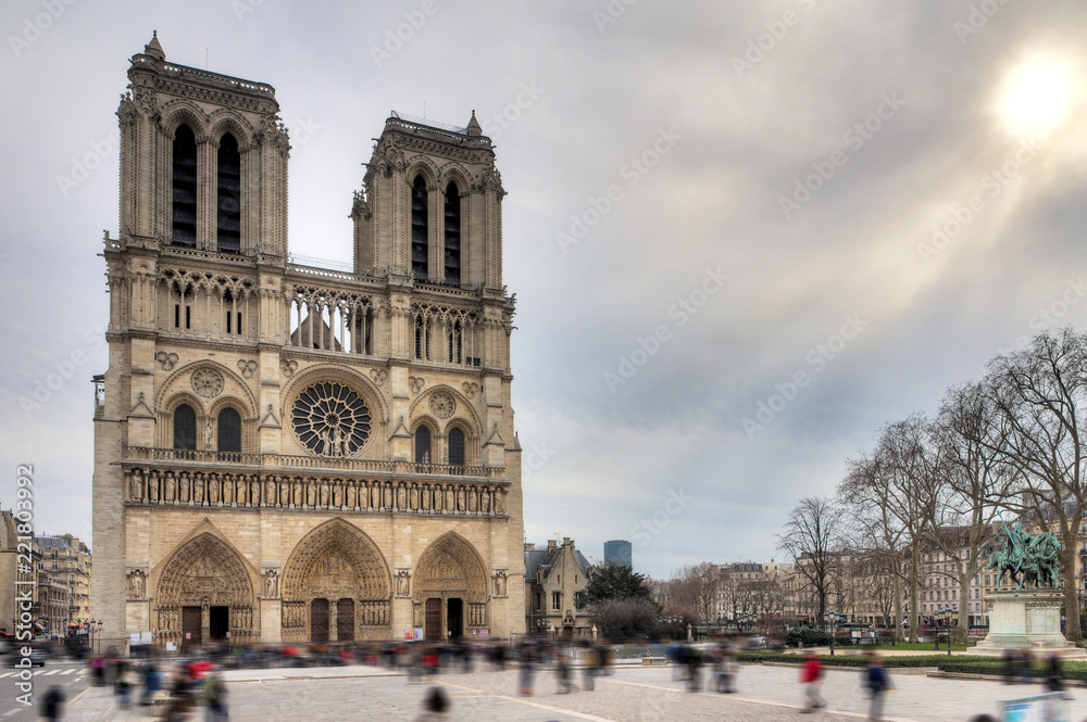 Front view of the Notre-Dame Cathedral in Paris with a moody sky in winter
