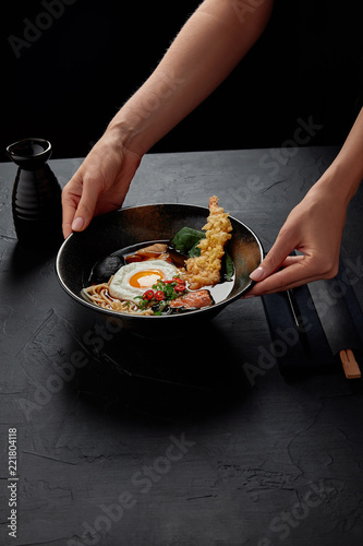 cropped shot of person holding bowl with delicious traditional japanese soup