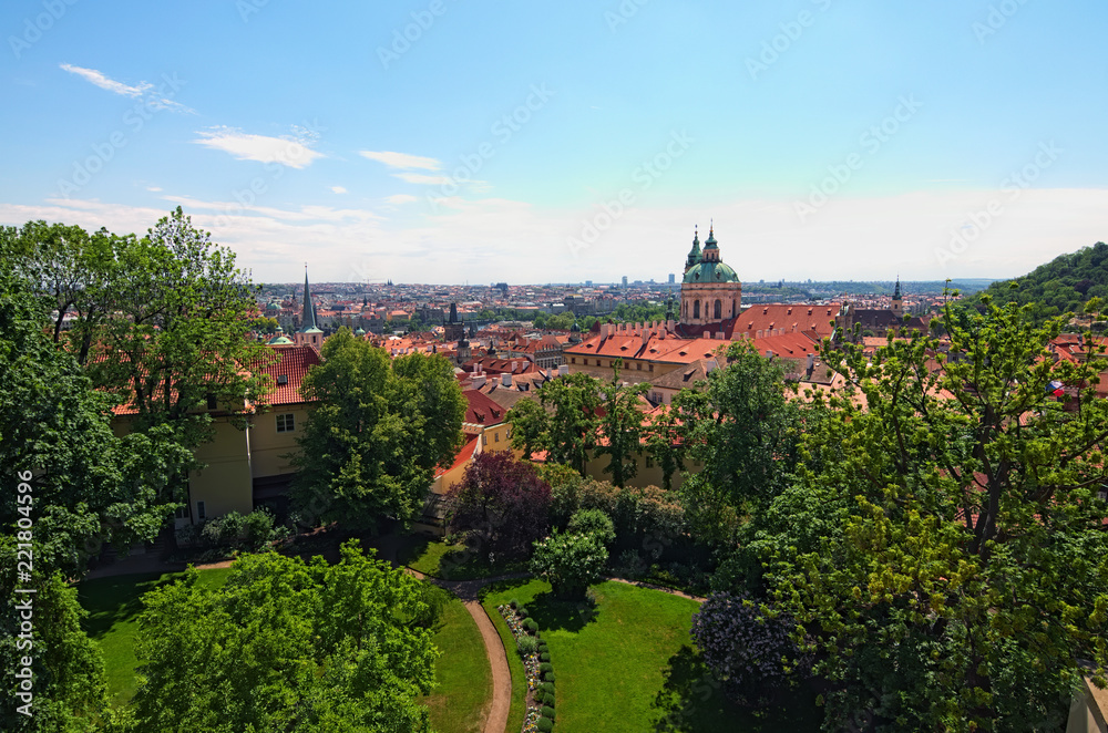 Skyline aerial view of old town Prague, ancient buildings and red tile roofs against blue sky. Selective focus with wide angle lens. Spring sunny day. Prague. Czech Republic