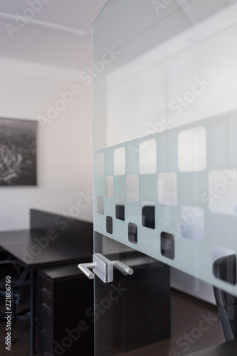 Office space interior. Interior of a modern office. Transparent door with metal handles