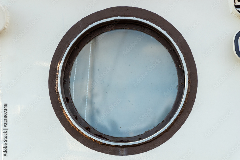 The porthole in the ship's cabin is outside The porthole in the ship's cabin is outside