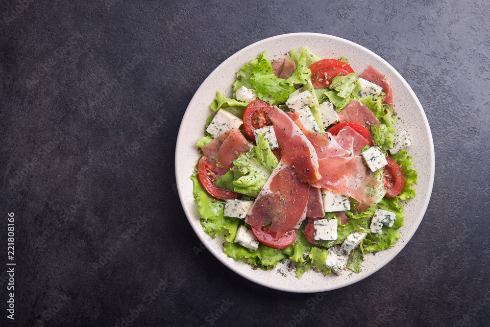 Fresh salad with prosciutto, tomato, lettuce and cheese blue Fresh salad with prosciutto, tomato, lettuce and cheese blue