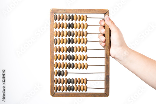 Accounting concept. Female hand holding vintage abacus isolated on white background.