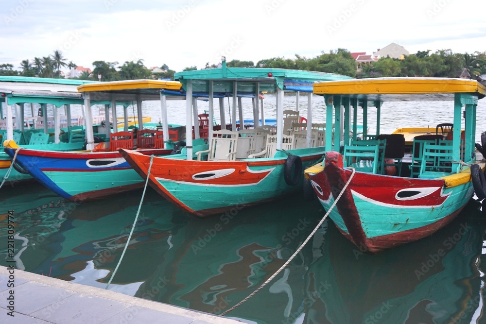 Colorful tour boats moored along the river in Hoi An Vietnam
