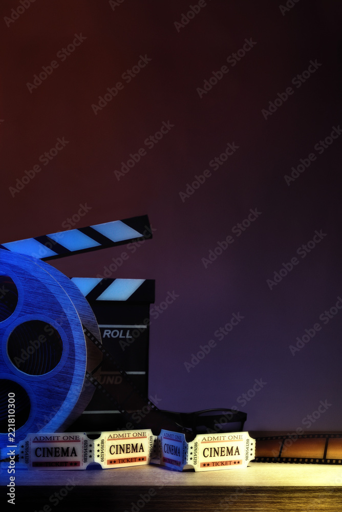 Fototapeta premium Equipment and elements of cinema with dark blue background vertical